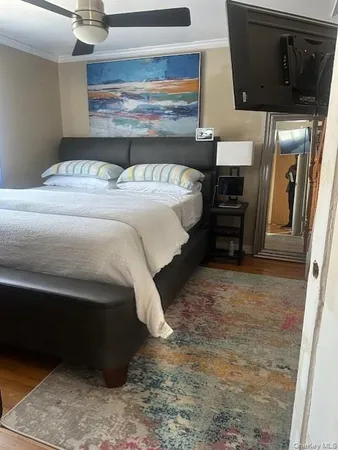 a bedroom with a bed and a microwave