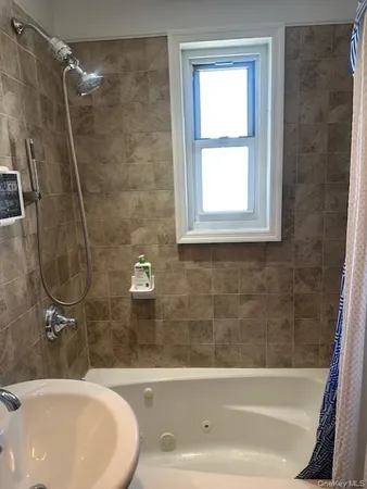 a bathroom with a sink a bathtub and a shower