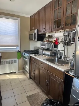 a kitchen with stainless steel appliances a sink a stove a microwave and cabinets