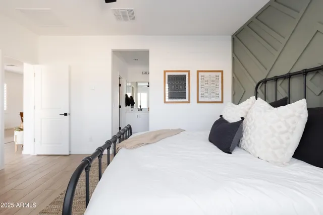 a bedroom with a bed and wooden floor