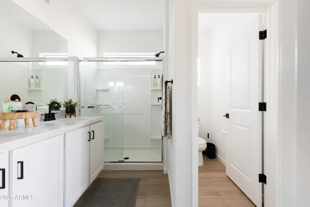 a bathroom with a shower and a sink