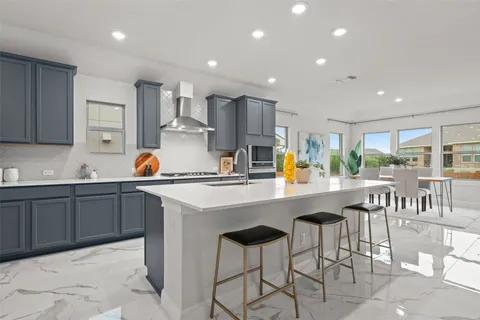 a kitchen with stainless steel appliances a sink a counter top space cabinets and a center island