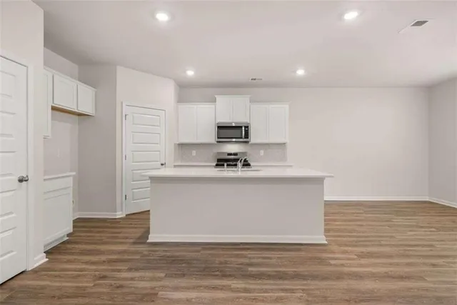 a view of kitchen refrigerator and microwave