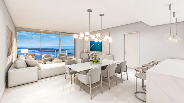 a living room with furniture a chandelier and a dining table