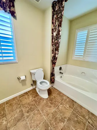 a bathroom with a toilet and a bathtub