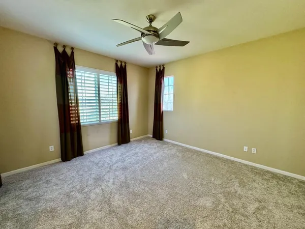a view of a livingroom with a ceiling fan and a window