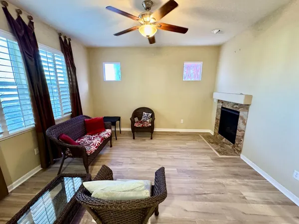 a view of a livingroom with furniture and a ceiling fan