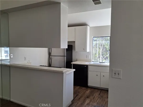 a utility room with cabinets washer and dryer