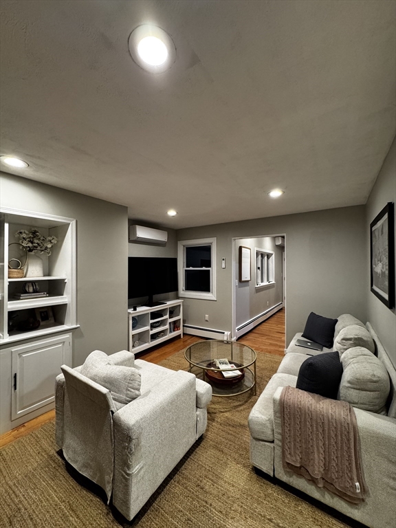 83 Chelsea Street, Unit 2 Boston, MA 02128 - Photo 4 of 7 a living room with furniture flat screen tv and large window