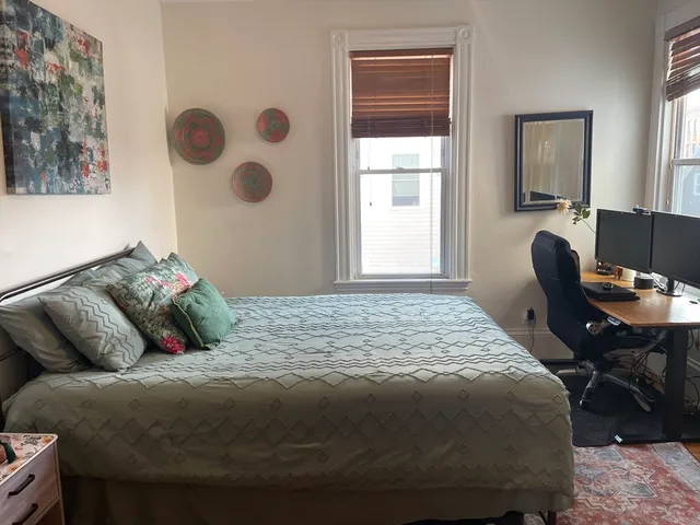 a bedroom with a bed and window