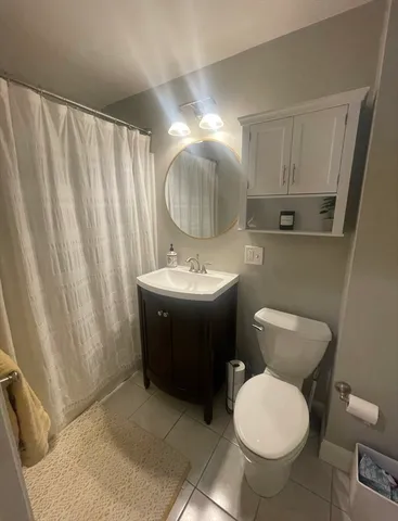 a bathroom with a toilet a sink and a mirror