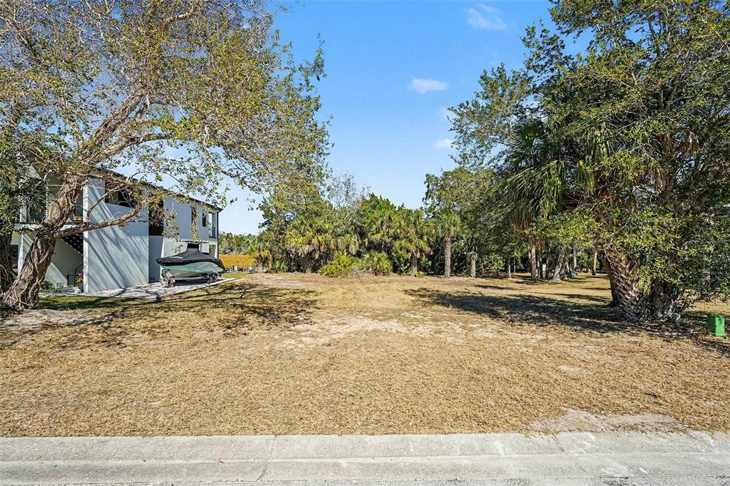 7657 Gulf Way Hudson, FL 34667 - Photo 2 of 14 a view of a yard with a tree