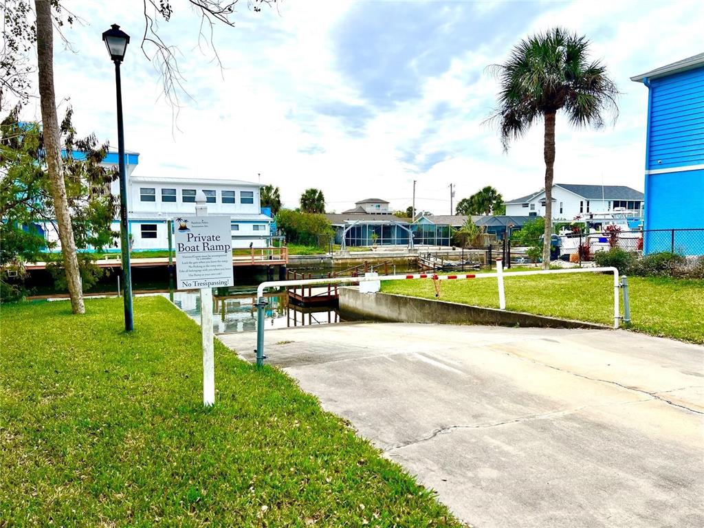 7657 Gulf Way Hudson, FL 34667 - Photo 5 of 14 a garden with swimming pool and tall trees