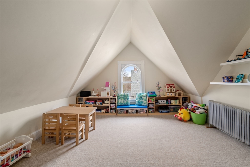 357 Crescent Street Waltham, MA 02453 - Photo 31 of 41 a living room with furniture and a chandelier