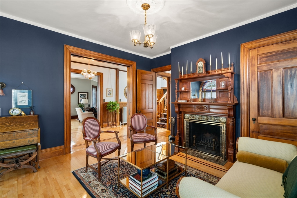 357 Crescent Street Waltham, MA 02453 - Photo 4 of 41 a living room with furniture a fireplace and a chandelier