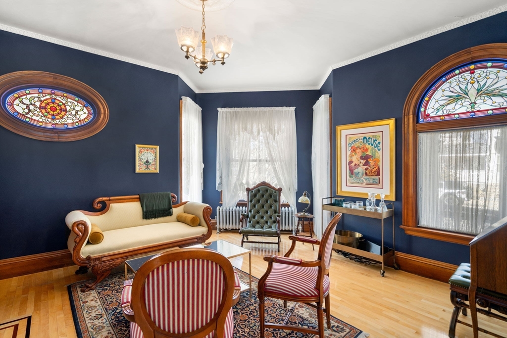 357 Crescent Street Waltham, MA 02453 - Photo 5 of 41 a living room with furniture a table and a large window