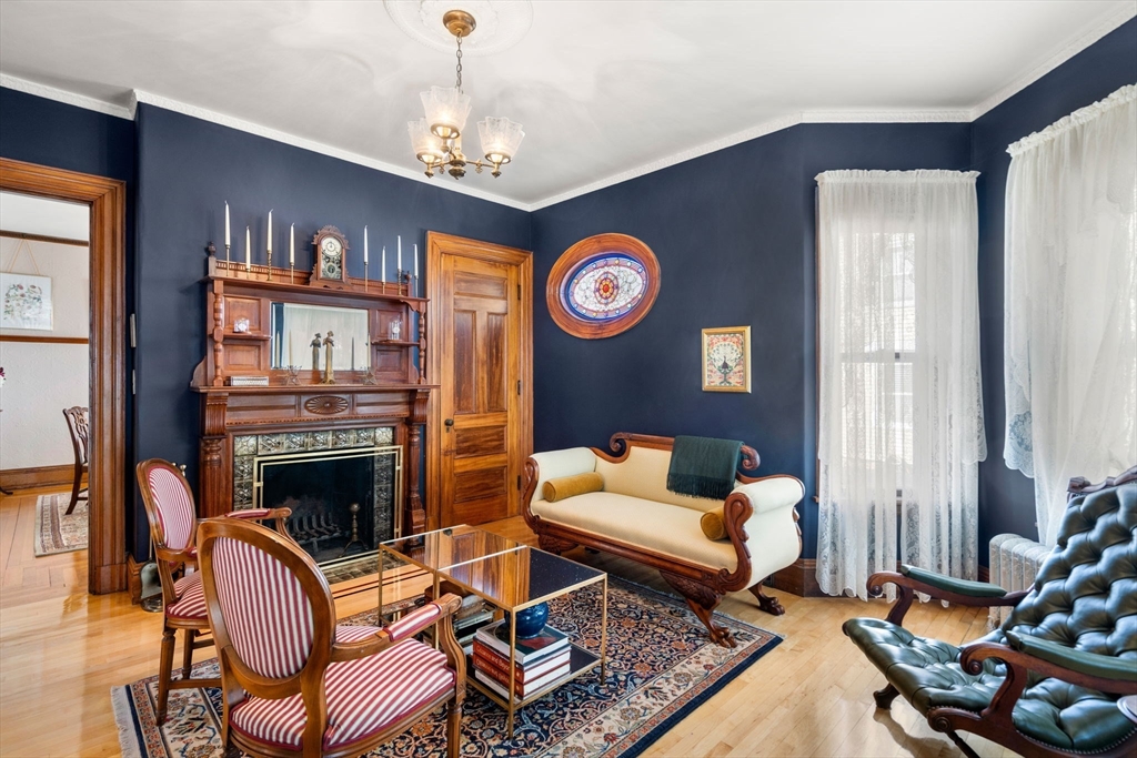 357 Crescent Street Waltham, MA 02453 - Photo 6 of 41 a living room with furniture and a fireplace