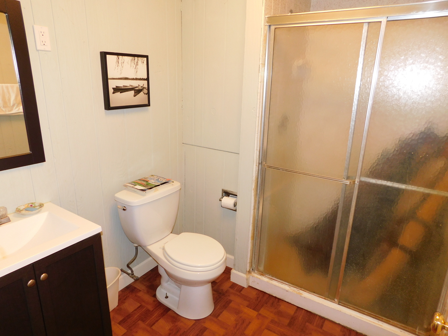 7737 Barnard Mill Road Richmond, IL 60071 - Photo 24 of 40 a white toilet sitting next to a bathroom sink
