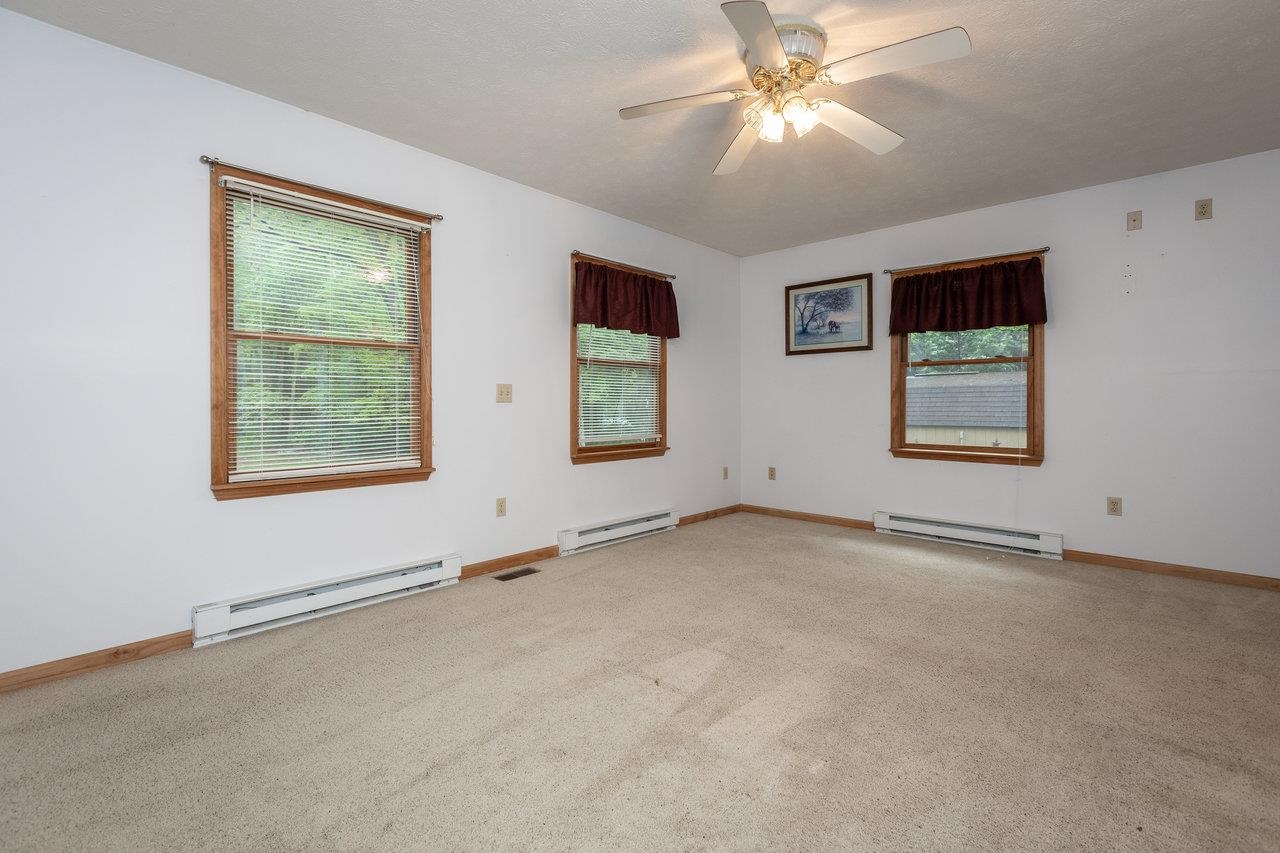 9385 Briery Branch Road Dayton, VA 22821 - Photo 23 of 75 a view of an empty room with window and chandelier fan