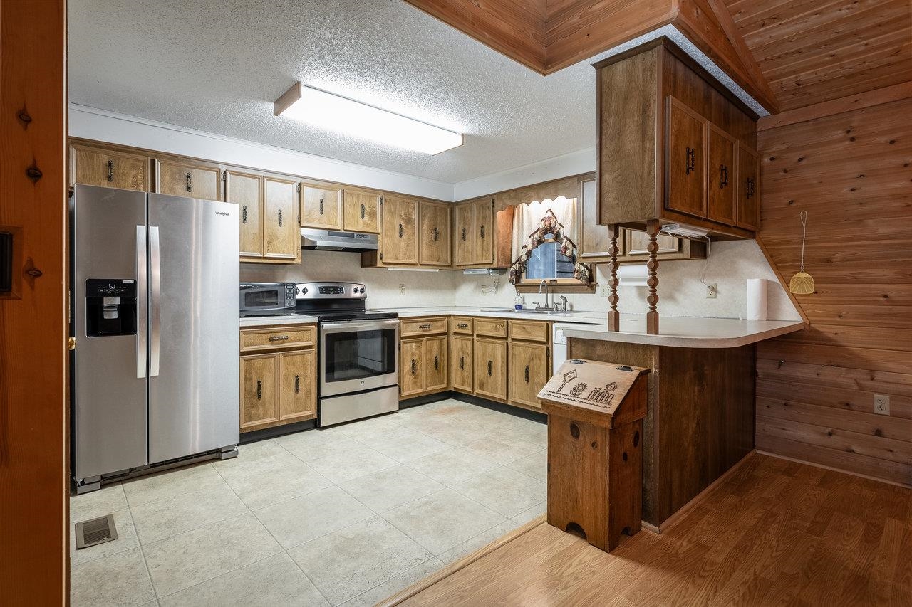 9385 Briery Branch Road Dayton, VA 22821 - Photo 8 of 75 a kitchen with stainless steel appliances granite countertop a sink stove and refrigerator