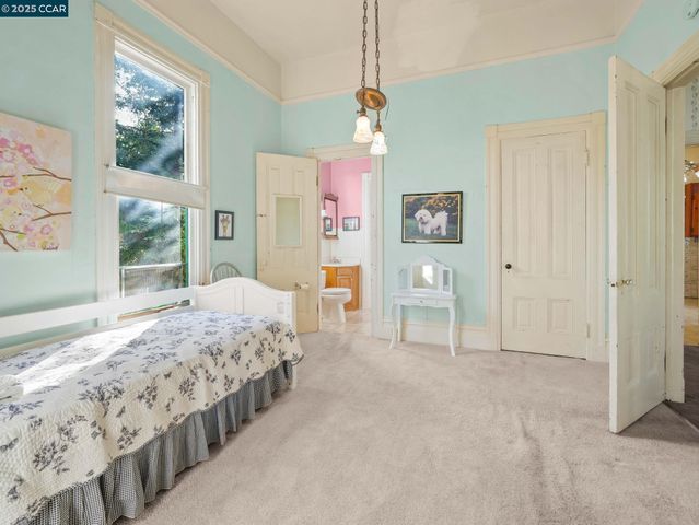 a bedroom with double bed and a window