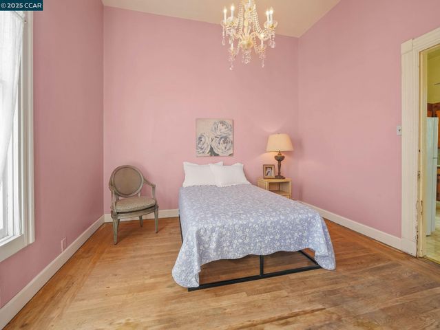 a bedroom with a bed table and chair