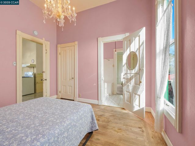 a bedroom with a bed and a chandelier