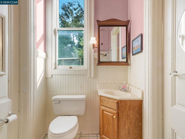 a bathroom with a sink a toilet and a window