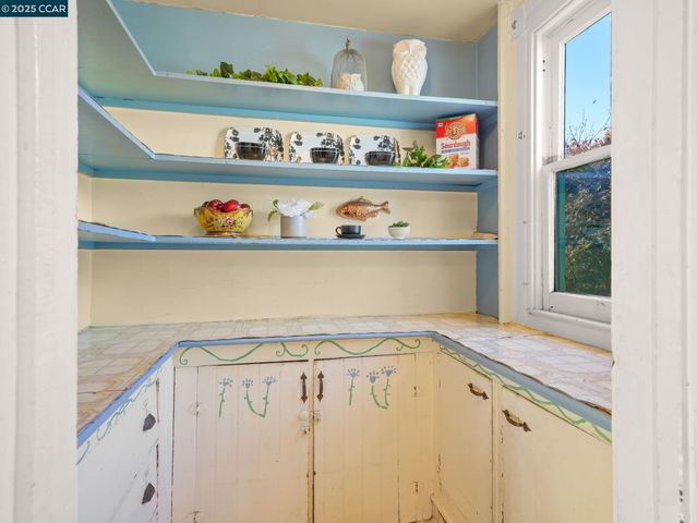 a kitchen with a refrigerator and a stove