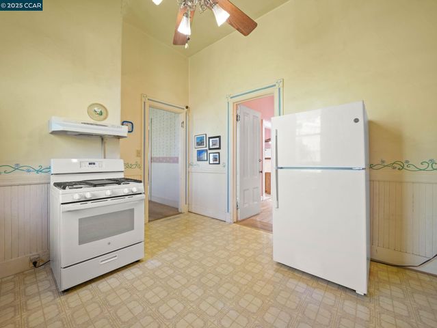 a kitchen with a refrigerator and cabinets