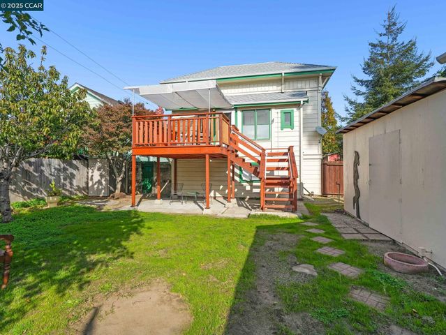 a view of a backyard with wooden fence
