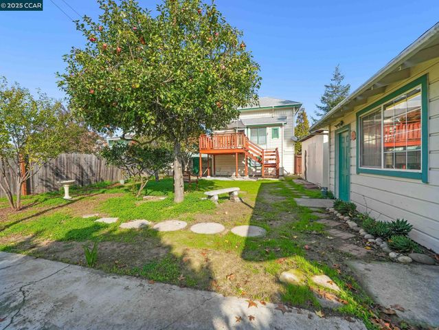 a view of a house with backyard sitting area and garden