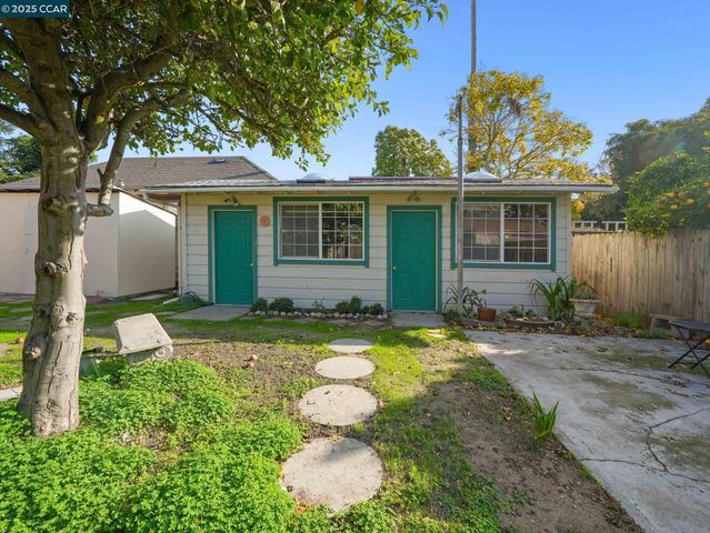 a living room with furniture a dining table and chairs with wooden floor