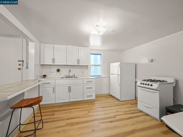 a spacious bedroom with a bed and a wooden floor