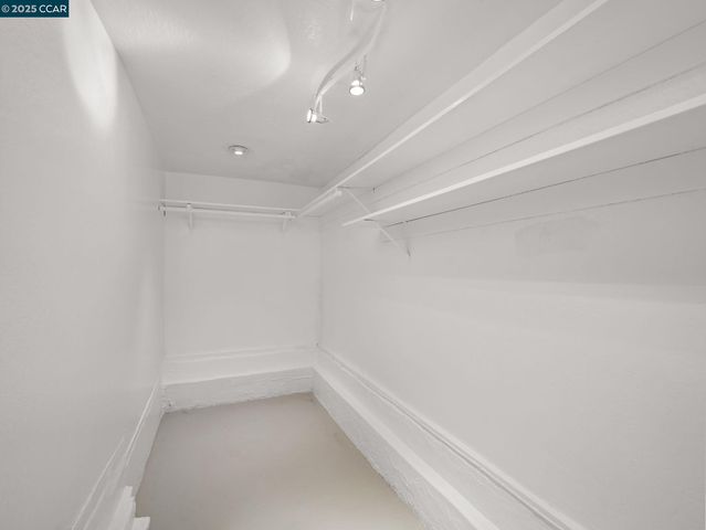 a room with furniture a refrigerator and a table