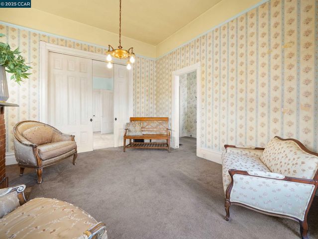 a living room with furniture and a chandelier