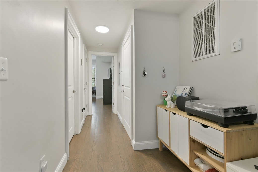 135 Havre Street, Unit 2 Boston, MA 02128 - Photo 13 of 17 a view of a hallway with washer and dryer