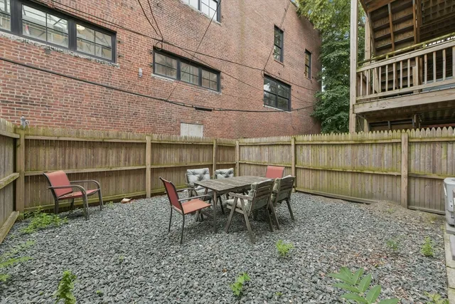 a view of an outdoor sitting area with brick walls