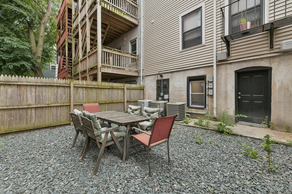 135 Havre Street, Unit 2 Boston, MA 02128 - Photo 15 of 17 a backyard of a house with table and chairs
