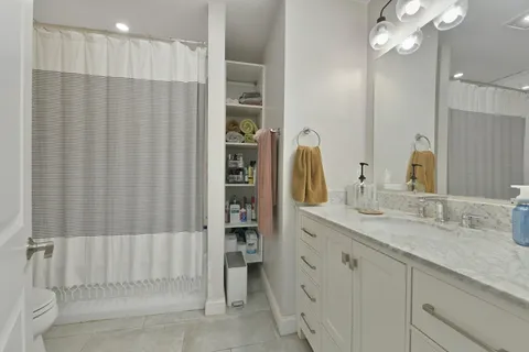 a bathroom with a double vanity sink and a mirror