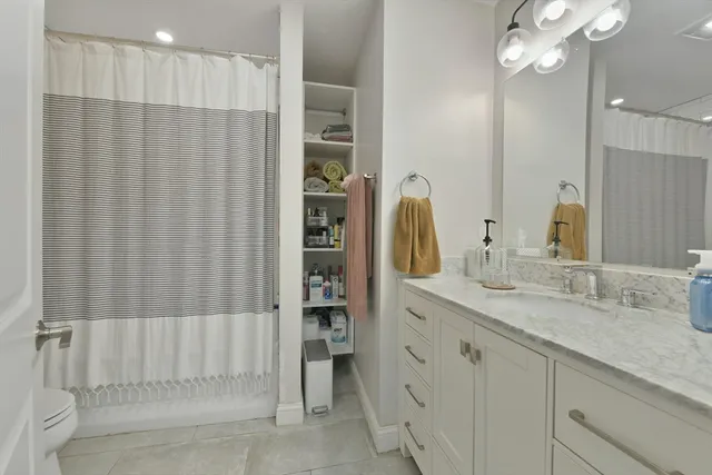 a bathroom with a double vanity sink and a mirror