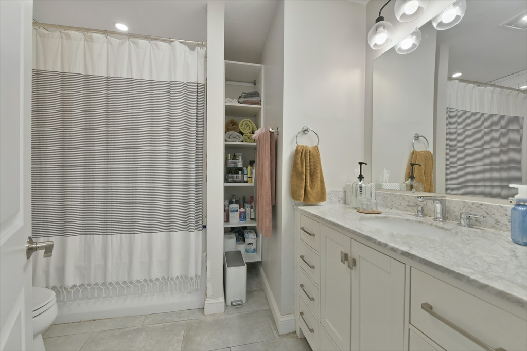 135 Havre Street, Unit 2 Boston, MA 02128 - Photo 10 of 17 a bathroom with a double vanity sink and a mirror