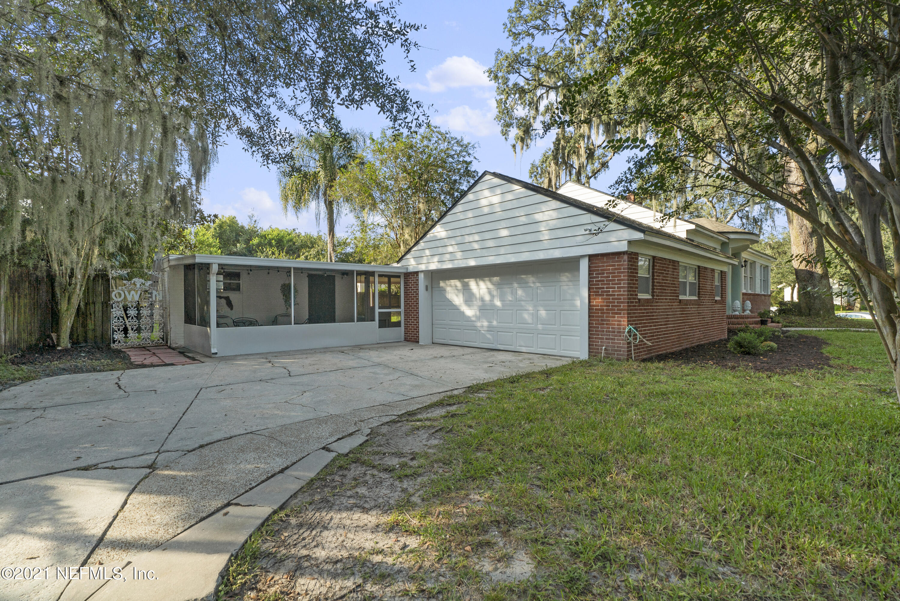 3010 Jolly Road Jacksonville, FL 32207 - Photo 39 of 41 a front view of a house with a garden and trees