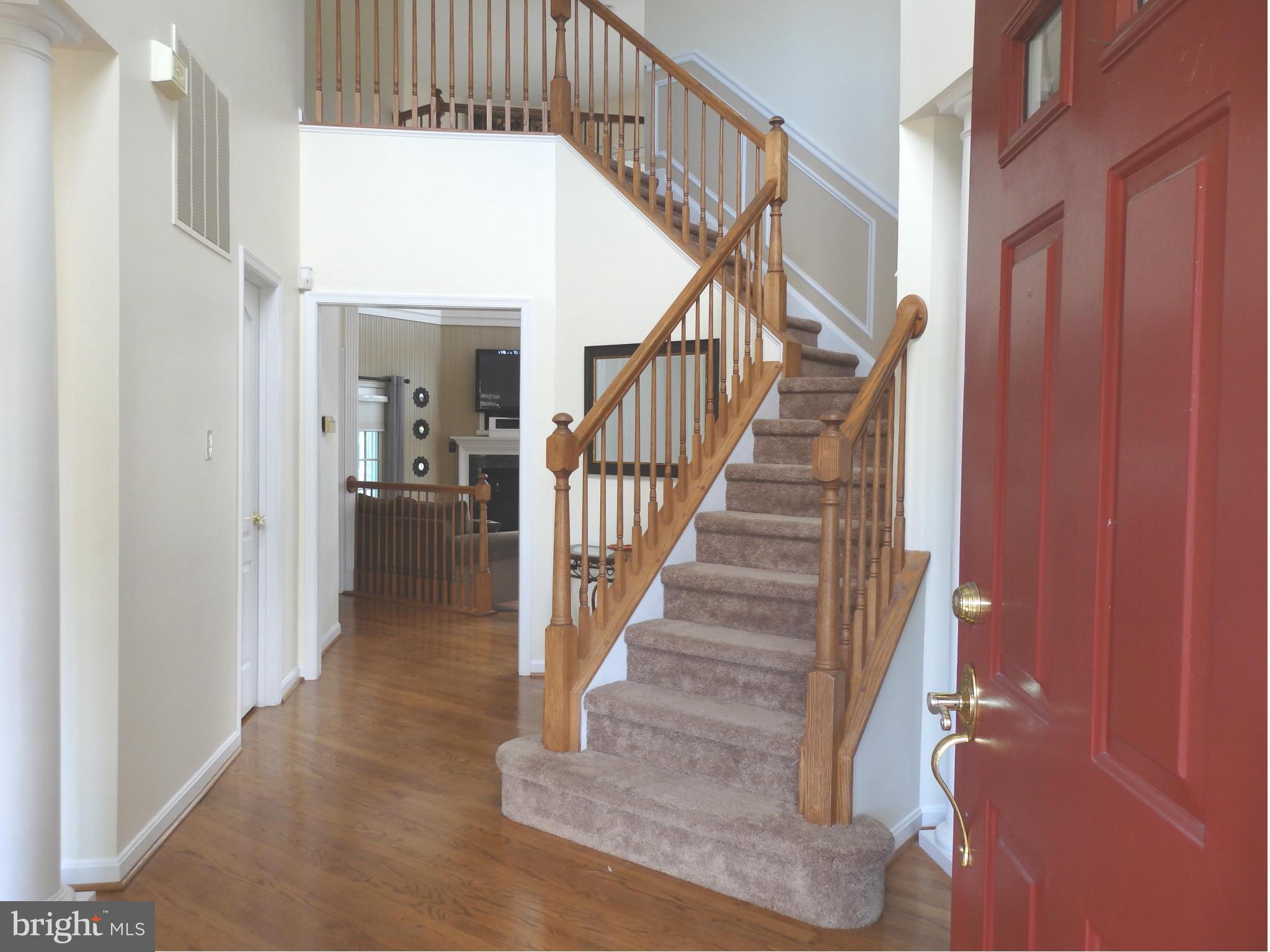 2543 Bear Den Road Frederick, MD 21701 - Photo 2 of 30 a view of staircase with lots of frames on wall and wooden floor