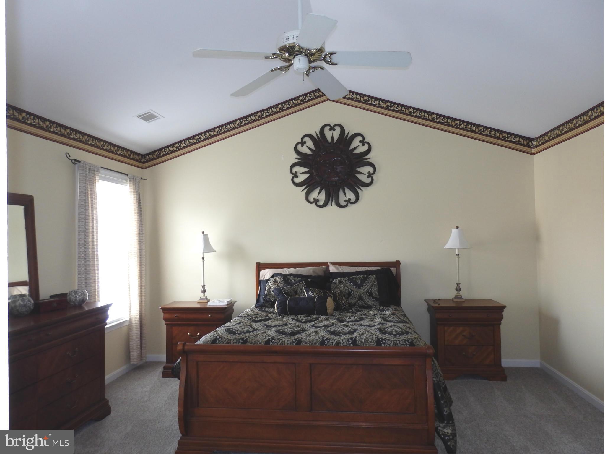 2543 Bear Den Road Frederick, MD 21701 - Photo 17 of 30 a bedroom with a bed and a chandelier