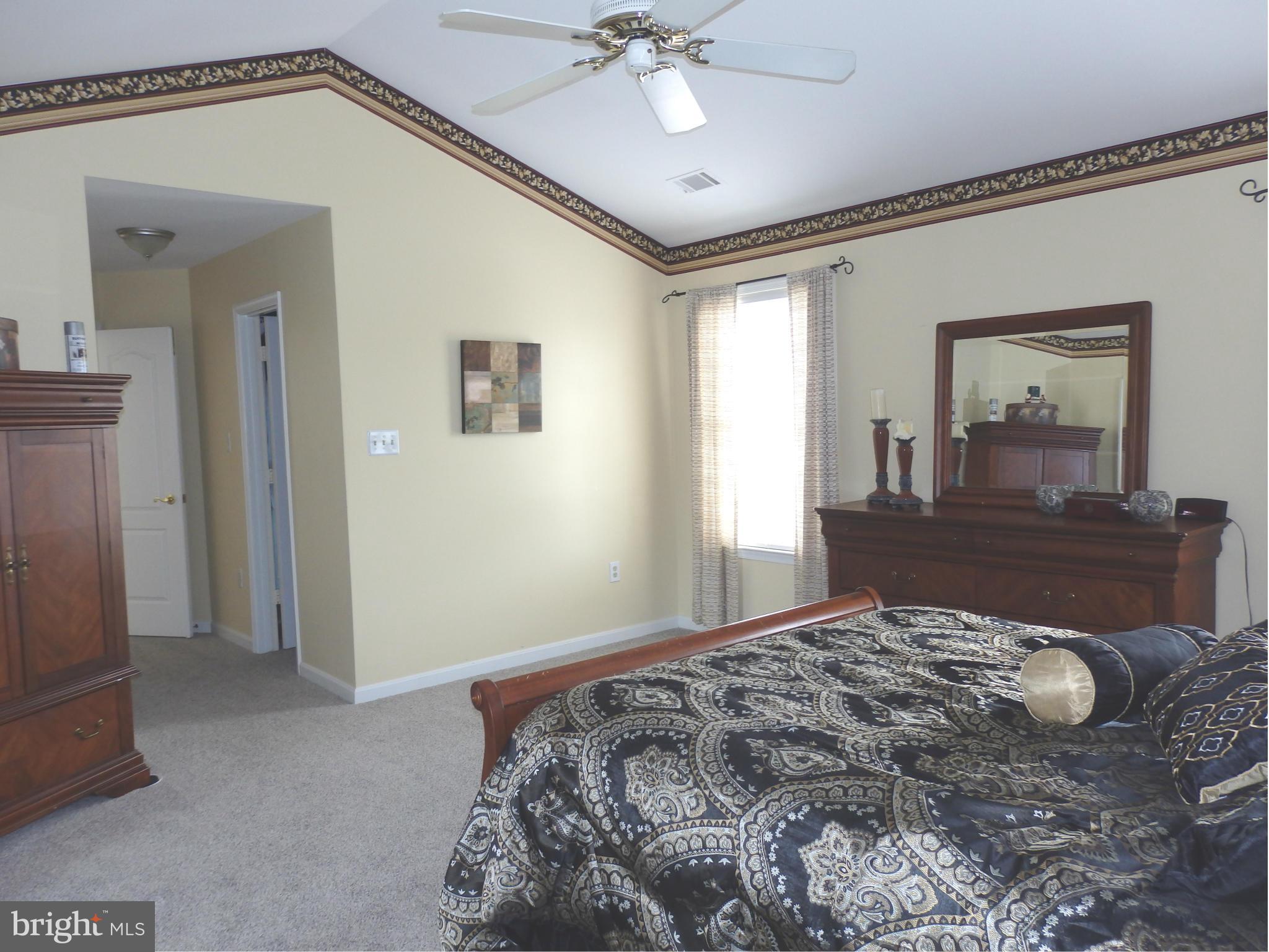 2543 Bear Den Road Frederick, MD 21701 - Photo 19 of 30 a bedroom with a bed and a chandelier