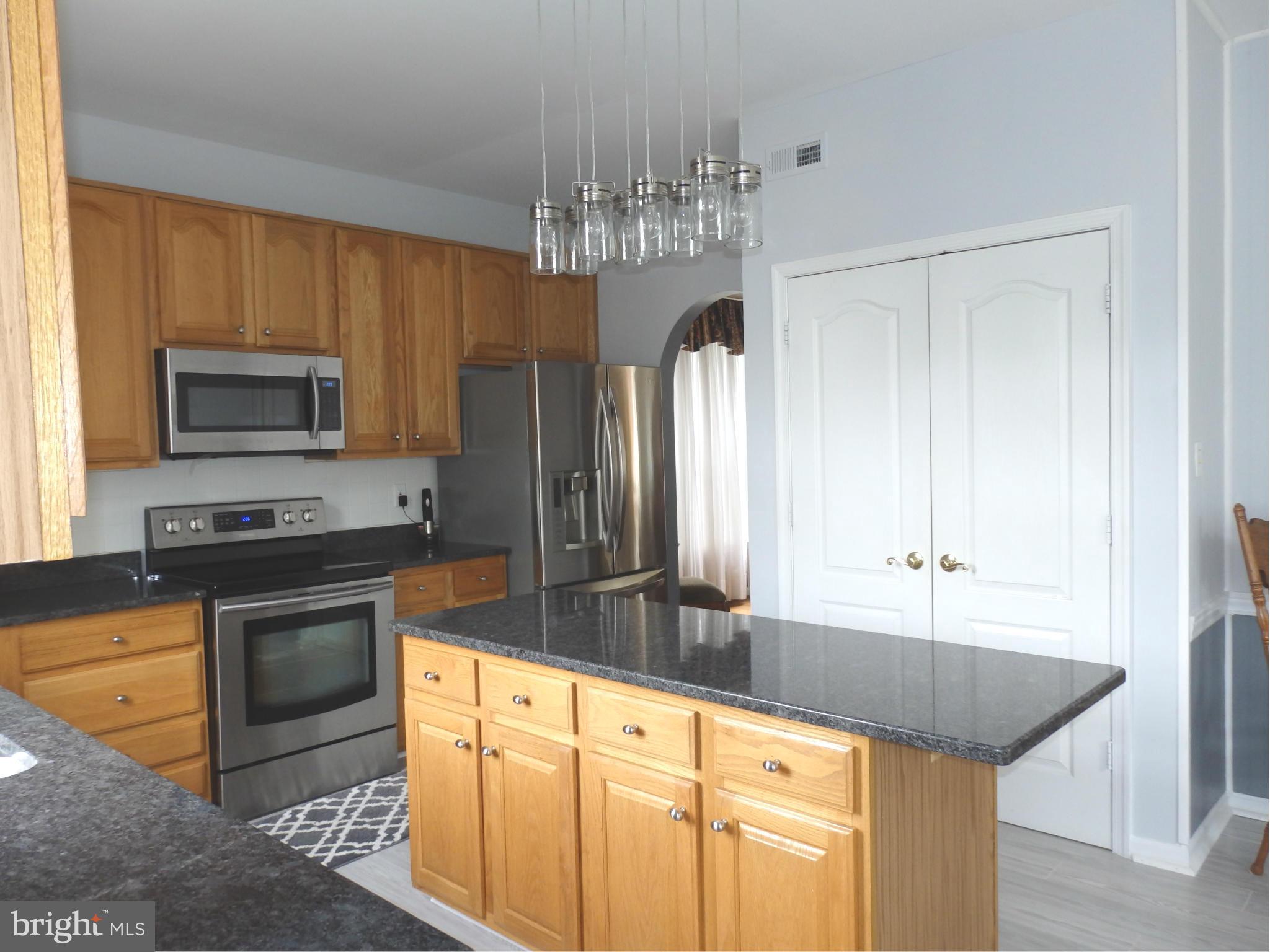 2543 Bear Den Road Frederick, MD 21701 - Photo 8 of 30 a kitchen with stainless steel appliances granite countertop a sink stove and refrigerator