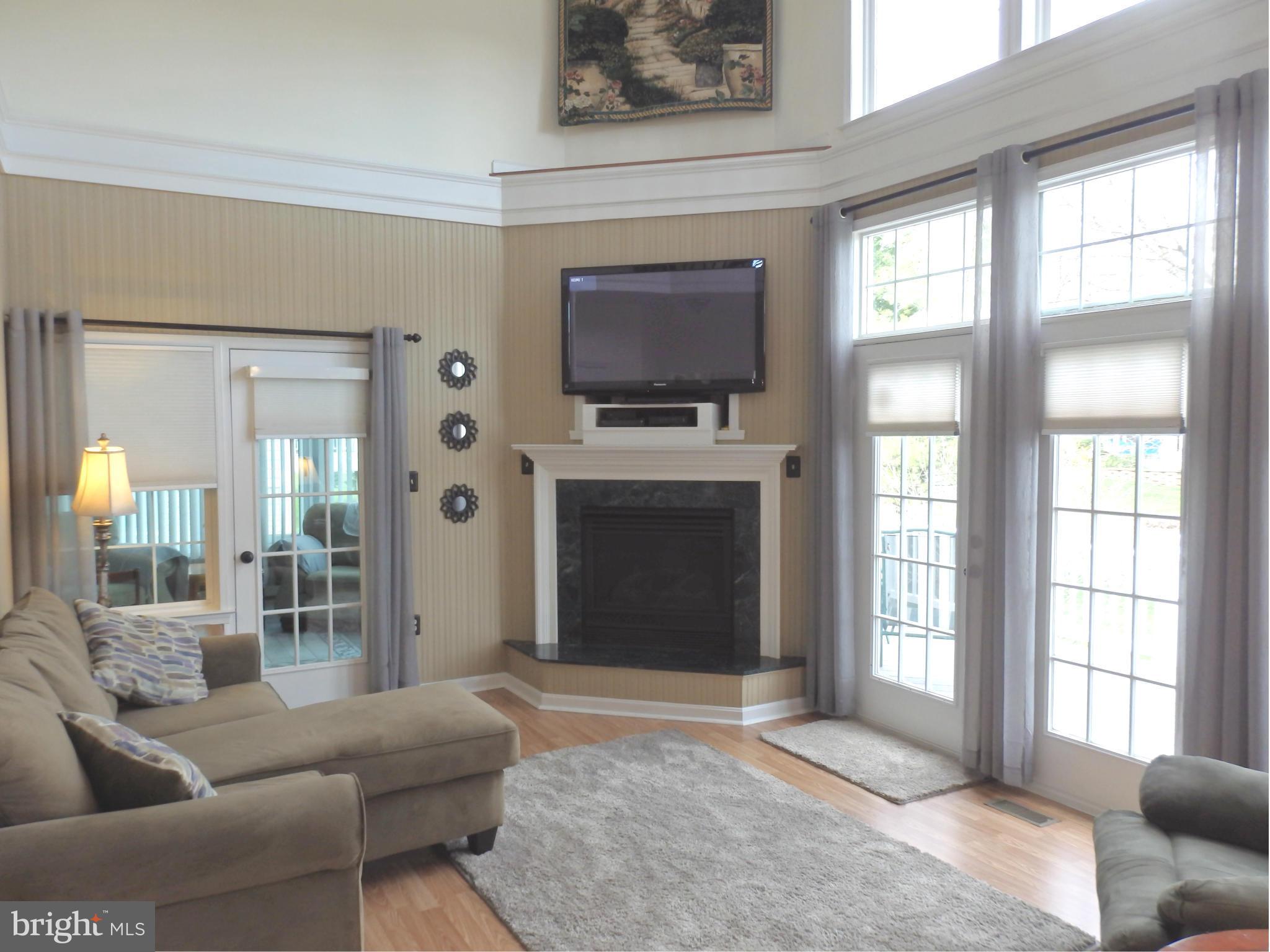2543 Bear Den Road Frederick, MD 21701 - Photo 10 of 30 a living room with furniture a flat screen tv and a fireplace