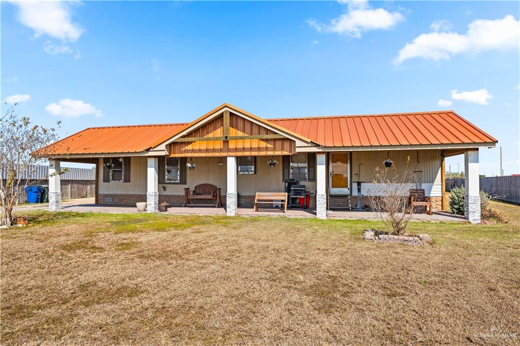 48 Gladiola Street Alamo, TX 78516 - Photo 1 of 14 a front view of a house with a garden and patio