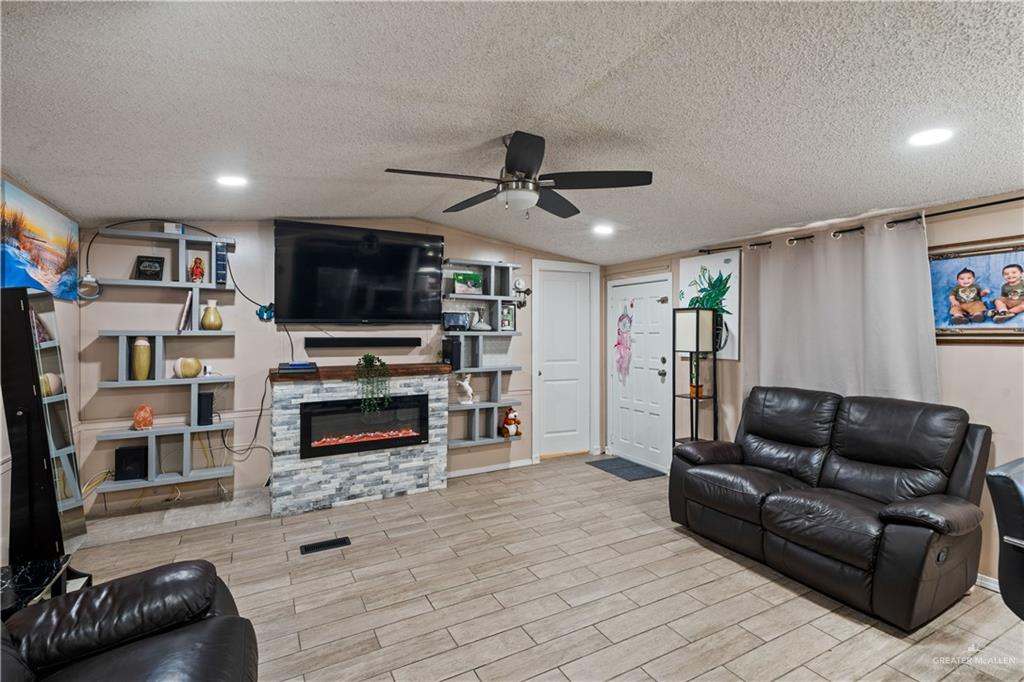 48 Gladiola Street Alamo, TX 78516 - Photo 10 of 14 a living room with furniture and a flat screen tv